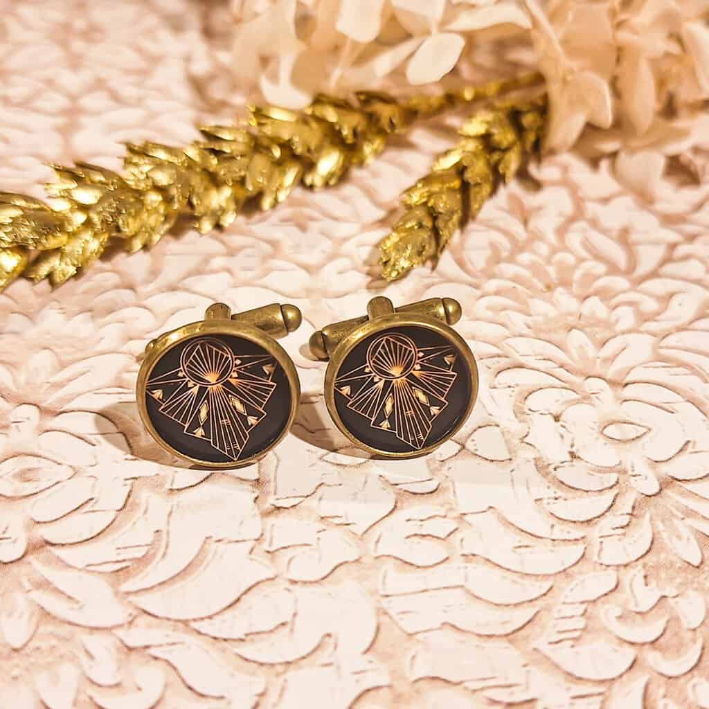 Gros plan sur le motif art déco bronze avec résine transparente, mettant en valeur les détails élégants.