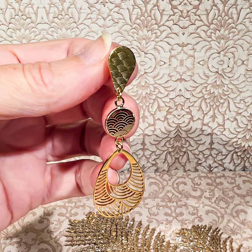 Gros plan sur une boucle goutte japonaise en résine, montrant ses nuances uniques faites main.