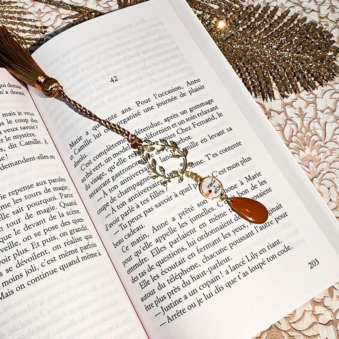 Marque-pages wish pompon sequin marron couronne laurier sur un livre